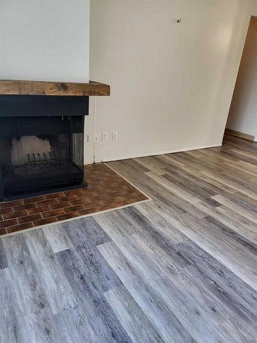 1-44-3950 23 Avenue South, Lethbridge, AB - Indoor Photo Showing Living Room With Fireplace