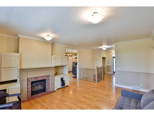 179 E 100 S, Raymond, AB - Indoor Photo Showing Living Room With Fireplace