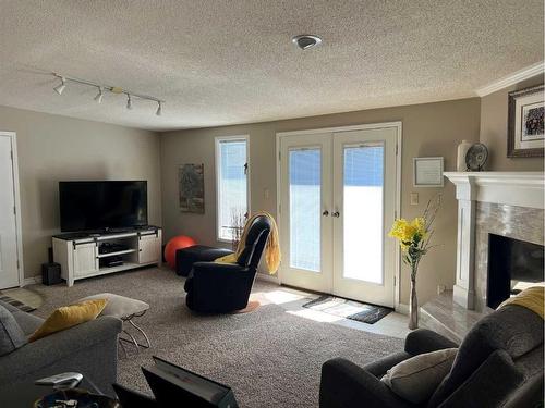 1237 Glacier Drive South, Lethbridge, AB - Indoor Photo Showing Living Room With Fireplace