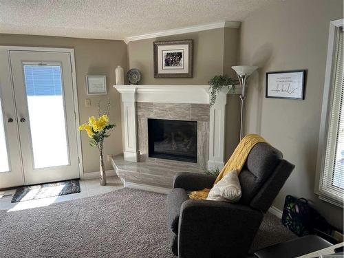 1237 Glacier Drive South, Lethbridge, AB - Indoor Photo Showing Living Room With Fireplace