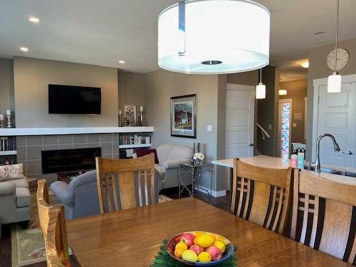 170 Crocus Terrace West, Lethbridge, AB - Indoor Photo Showing Dining Room With Fireplace