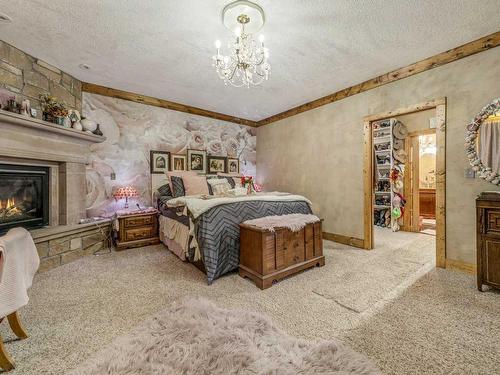 208 3 Street, Warner, AB - Indoor Photo Showing Bedroom With Fireplace