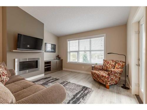 4-53 Aquitania Circle West, Lethbridge, AB - Indoor Photo Showing Living Room With Fireplace