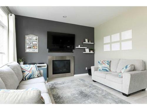 466 Mt Sundance Landing West, Lethbridge, AB - Indoor Photo Showing Living Room With Fireplace