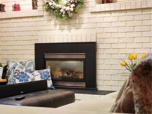 3805 Redwood Road South, Lethbridge, AB - Indoor Photo Showing Living Room With Fireplace