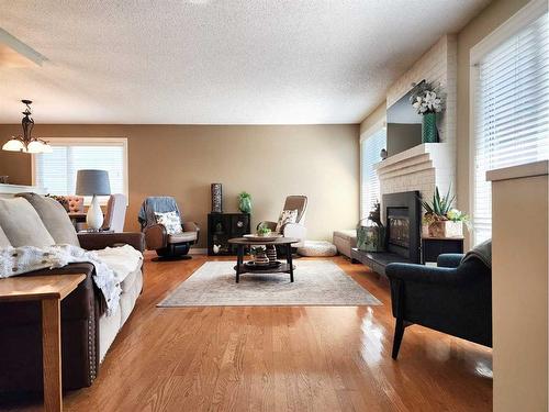 3805 Redwood Road South, Lethbridge, AB - Indoor Photo Showing Living Room With Fireplace