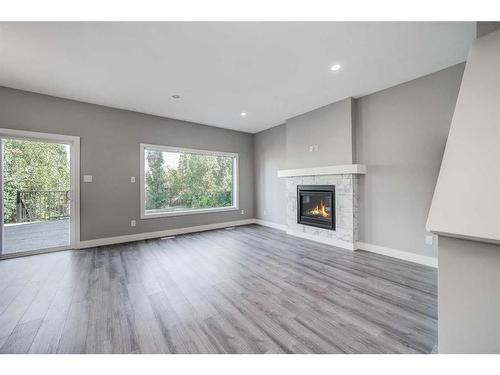 4401 40 Avenue South, Lethbridge, AB - Indoor Photo Showing Living Room With Fireplace