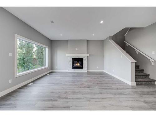 4401 40 Avenue South, Lethbridge, AB - Indoor Photo Showing Living Room With Fireplace