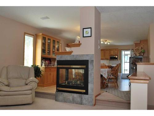 54 Cougar Road North, Lethbridge, AB - Indoor Photo Showing Living Room With Fireplace