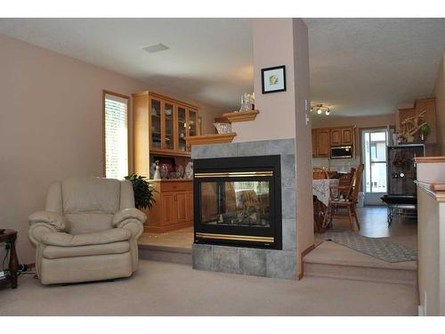 54 Cougar Road North, Lethbridge, AB - Indoor Photo Showing Living Room With Fireplace