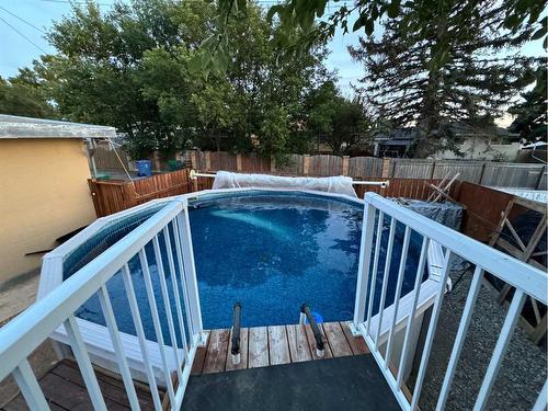 2218 6A Avenue North, Lethbridge, AB - Outdoor With Above Ground Pool With Backyard