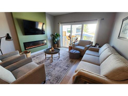 4617 26 Avenue South, Lethbridge, AB - Indoor Photo Showing Living Room With Fireplace