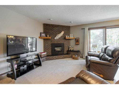 22 Mt Royal Place West, Lethbridge, AB - Indoor Photo Showing Living Room With Fireplace