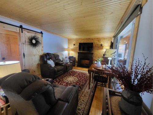 9 Mountain Vista Drive, Hill Spring, AB - Indoor Photo Showing Living Room With Fireplace