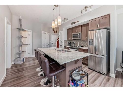 1108-3727 Sage Hill Drive Nw, Calgary, AB - Indoor Photo Showing Kitchen With Double Sink With Upgraded Kitchen