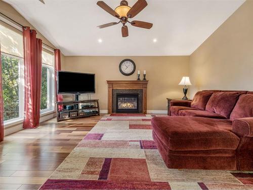 10 Couleesprings Place South, Lethbridge, AB - Indoor Photo Showing Living Room With Fireplace