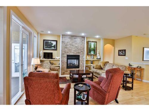 1203 Whispering Greens Place, Vulcan, AB - Indoor Photo Showing Living Room With Fireplace