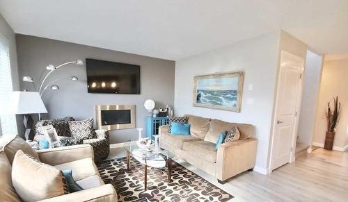 602 Mt Sundance Bay West, Lethbridge, AB - Indoor Photo Showing Living Room With Fireplace