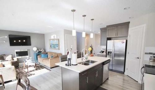 602 Mt Sundance Bay West, Lethbridge, AB - Indoor Photo Showing Kitchen With Fireplace With Stainless Steel Kitchen With Double Sink With Upgraded Kitchen