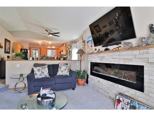 3 Squamish Boulevard West, Lethbridge, AB - Indoor Photo Showing Living Room With Fireplace