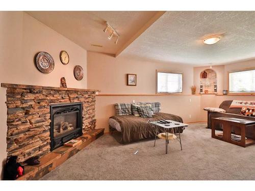 3 Squamish Boulevard West, Lethbridge, AB - Indoor Photo Showing Living Room With Fireplace