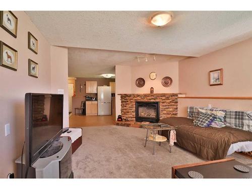 3 Squamish Boulevard West, Lethbridge, AB - Indoor Photo Showing Living Room With Fireplace