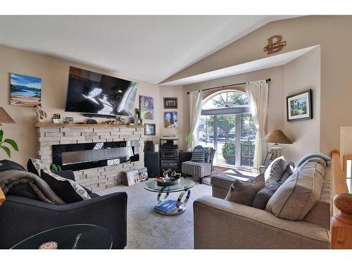 3 Squamish Boulevard West, Lethbridge, AB - Indoor Photo Showing Living Room With Fireplace