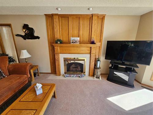 301 Centre Avenue, Milk River, AB - Indoor Photo Showing Living Room With Fireplace