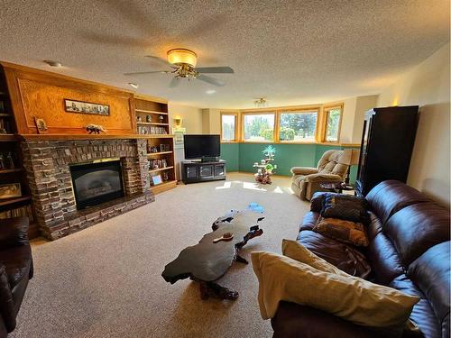 301 Centre Avenue, Milk River, AB - Indoor Photo Showing Living Room With Fireplace