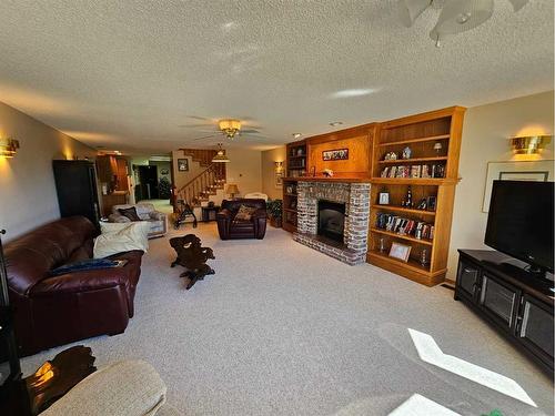 301 Centre Avenue, Milk River, AB - Indoor Photo Showing Other Room With Fireplace