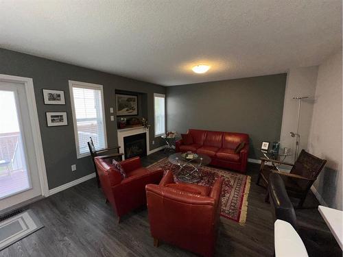 #4-404 Couleecreek Boulevard South, Lethbridge, AB - Indoor Photo Showing Living Room With Fireplace