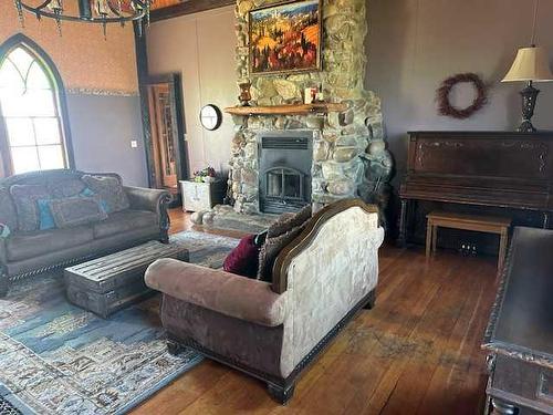 270002 Ab 505 Highway, Glenwood, AB - Indoor Photo Showing Living Room With Fireplace