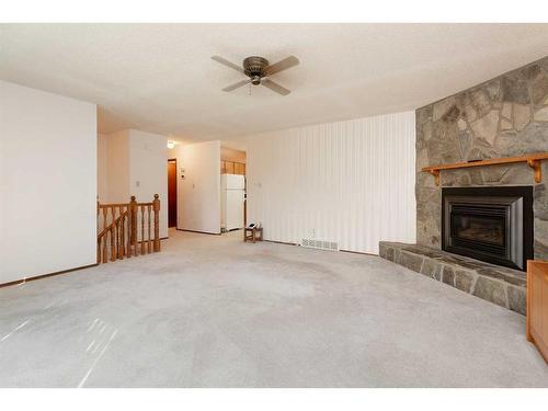 165 Purdue Court West, Lethbridge, AB - Indoor Photo Showing Living Room With Fireplace