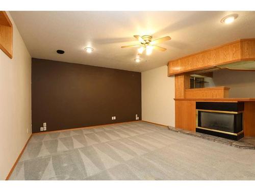 5407 52 Street, Taber, AB - Indoor Photo Showing Other Room With Fireplace