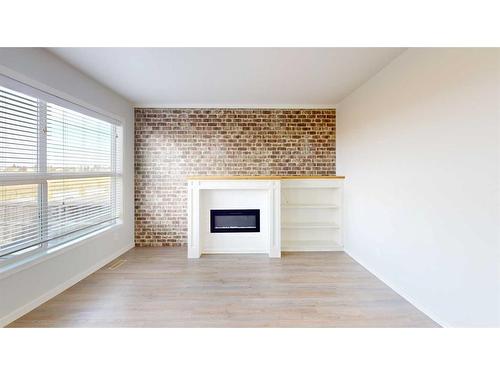 401 Devonia Way West, Lethbridge, AB - Indoor Photo Showing Other Room With Fireplace