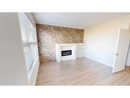 401 Devonia Way West, Lethbridge, AB - Indoor Photo Showing Living Room With Fireplace