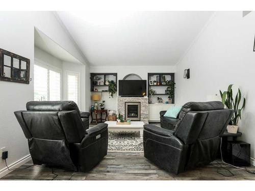 2803 48 Avenue South, Lethbridge, AB - Indoor Photo Showing Living Room With Fireplace