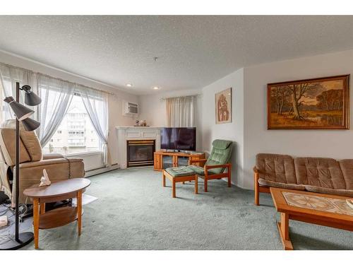 317-100 2 Avenue South, Lethbridge, AB - Indoor Photo Showing Living Room With Fireplace