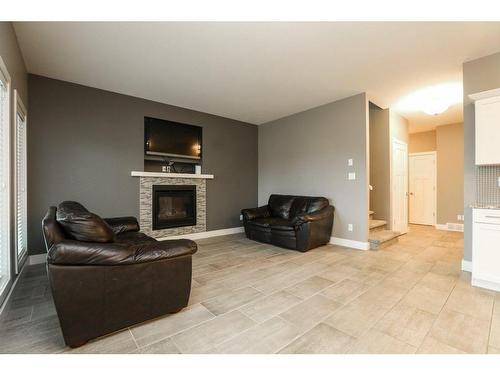 523 Firelight Place West, Lethbridge, AB - Indoor Photo Showing Living Room With Fireplace