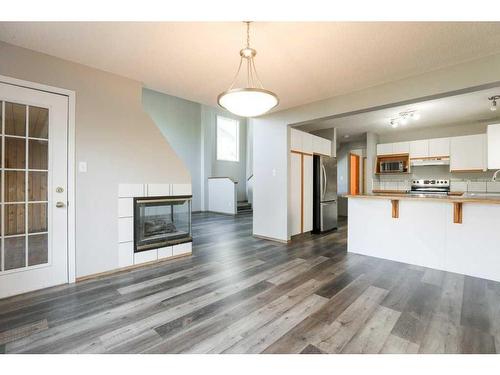 315 Heritage Crescent West, Lethbridge, AB - Indoor Photo Showing Kitchen With Fireplace