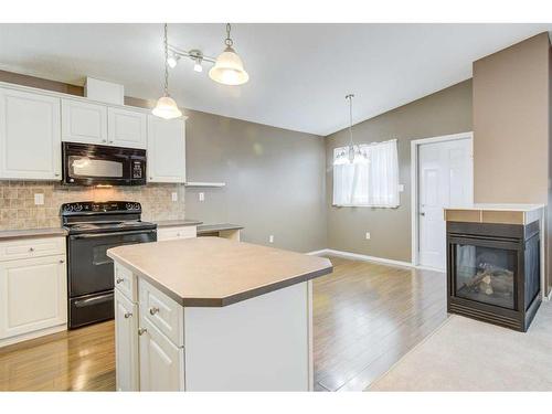 572 Sunridge Crescent West, Lethbridge, AB - Indoor Photo Showing Kitchen With Fireplace