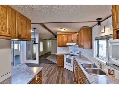 209 4 Avenue North, Champion, AB - Indoor Photo Showing Kitchen With Double Sink