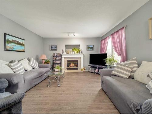 27 Canyon Court West, Lethbridge, AB - Indoor Photo Showing Living Room With Fireplace