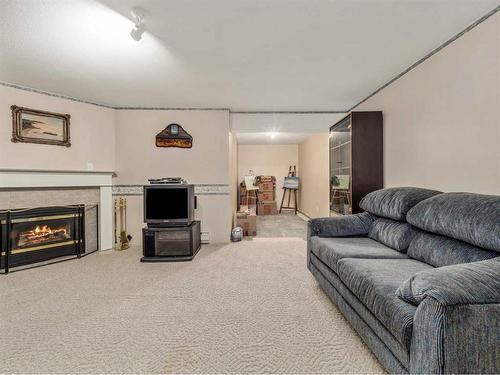 27 Canyon Court West, Lethbridge, AB - Indoor Photo Showing Living Room With Fireplace