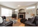 10 Squamish Bay West, Lethbridge, AB  - Indoor Photo Showing Living Room With Fireplace 