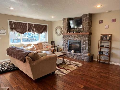 242W 100S, Raymond, AB - Indoor Photo Showing Living Room With Fireplace