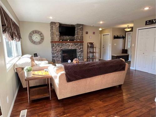 242W 100S, Raymond, AB - Indoor Photo Showing Living Room With Fireplace