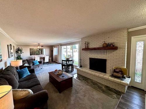 210 4 Street East, Cardston, AB - Indoor Photo Showing Living Room With Fireplace