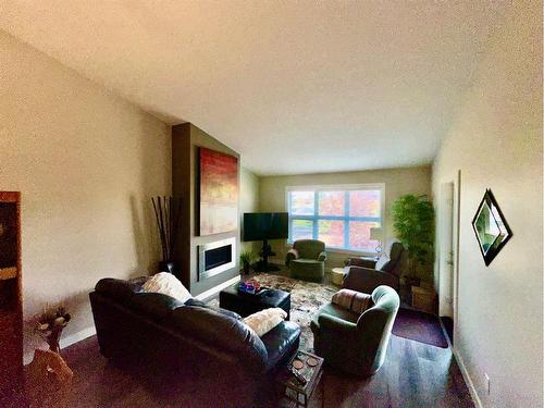 #3-47 Aquitania Circle West, Lethbridge, AB - Indoor Photo Showing Living Room With Fireplace