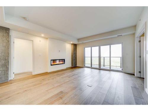 325-102 Scenic Drive North, Lethbridge, AB - Indoor Photo Showing Other Room With Fireplace